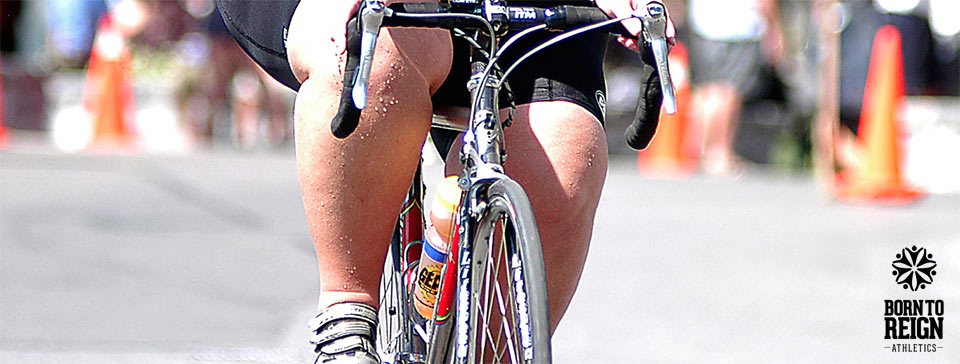 Legs of a plus size athlete cycling in a race.