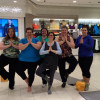 Plus size women holding tree yoga pose at Addition Elle sponsored class